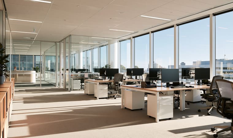 Open plan office with desks and floor-to-ceiling windows